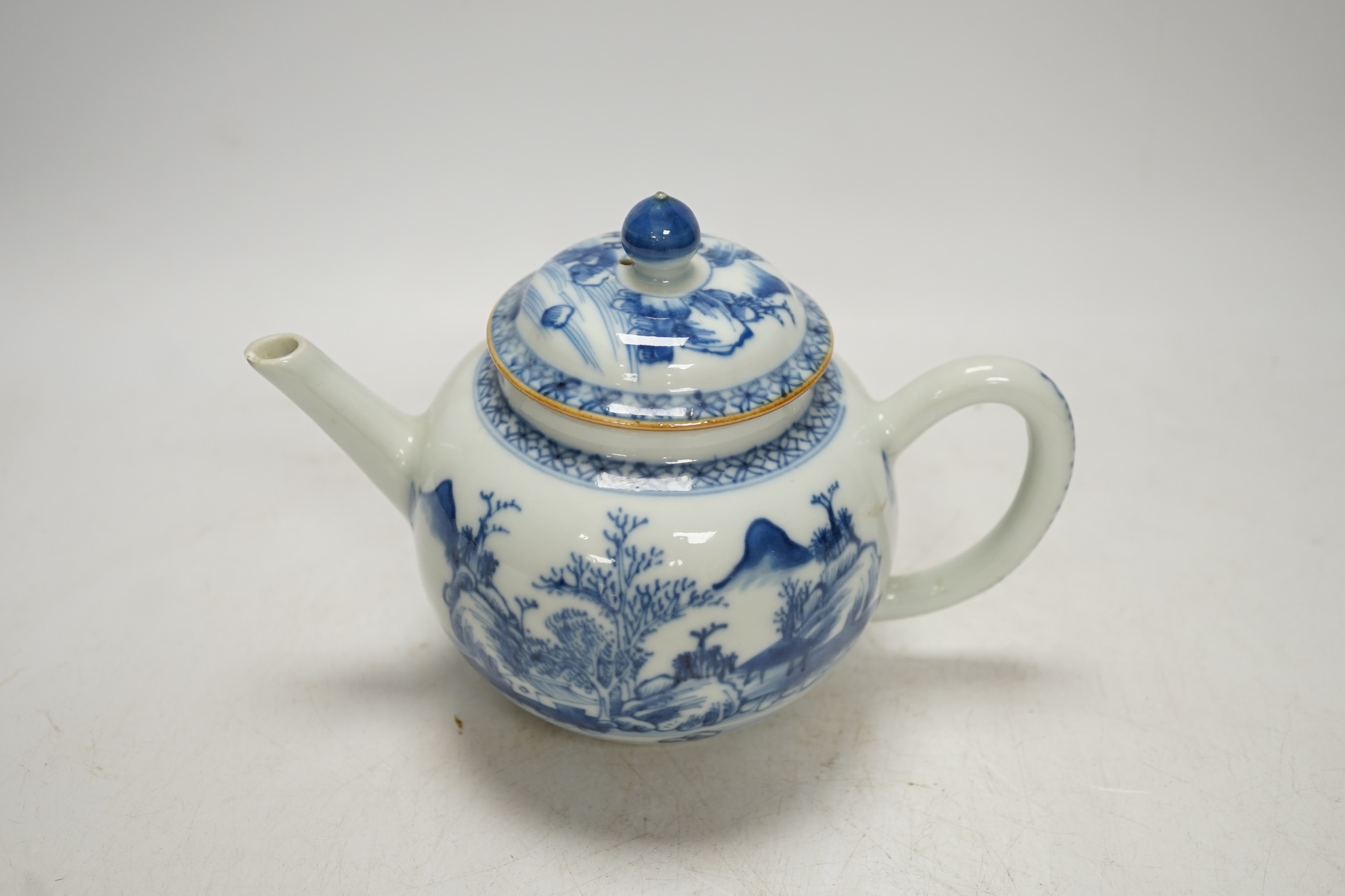 An 18th century Chinese blue and white teapot and cover, 12cm high. Condition - poor